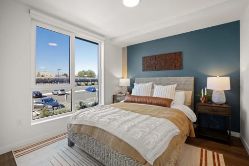 a bedroom with a bed and a large window