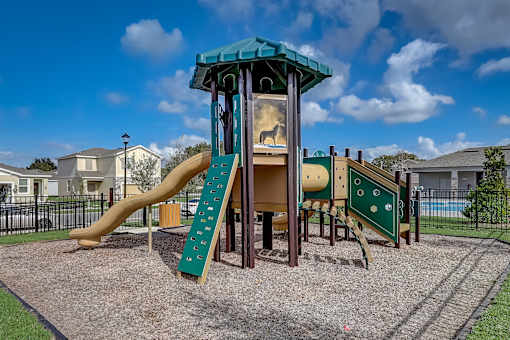 A playground with a slide and a wooden structure.