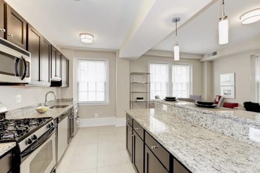 A kitchen with granite countertops and stainless steel appliances.
