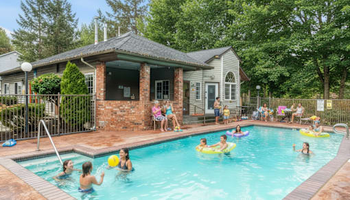 Apartments In Everett, WA, For Rent - Woodbrook - Gated Outdoor Pool Surrounded By Lush Greenery.