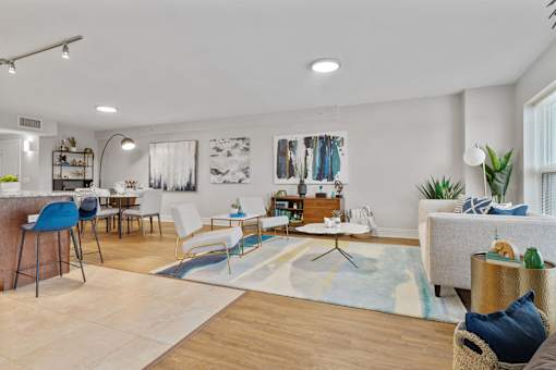 A modern living room with a blue chair and a white couch.