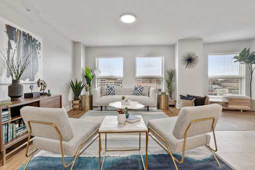 A living room with a white sofa and a coffee table.