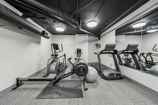 Fitness center with free weights and strength-training equipment at River 595