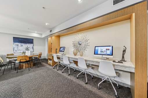 Resident business center with computers and workstations at River 595 Apartments