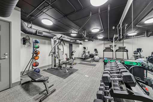 Resident fitness center with cardio equipment at River 595 Apartments