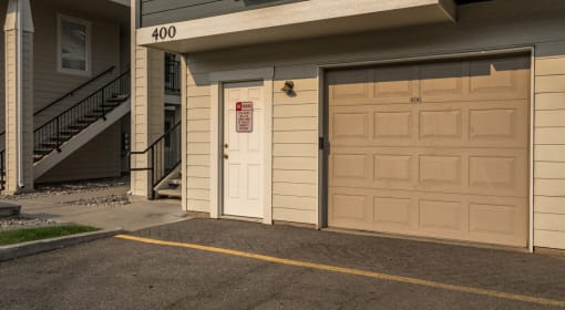Coeur d’Alene ID Apartments - Rockwood Lodge - Garage Door Next to Stairwells and a Parking Spot