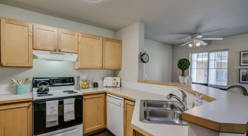 kitchen with double sink and oven and microwave and refrigerator