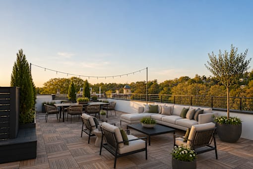 A patio with a table and chairs is set up on a rooftop.