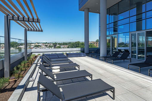 3thirty3 new rochelle ny apartment high rise photo of outdoor lounge area with lounge seating and trellis and city views