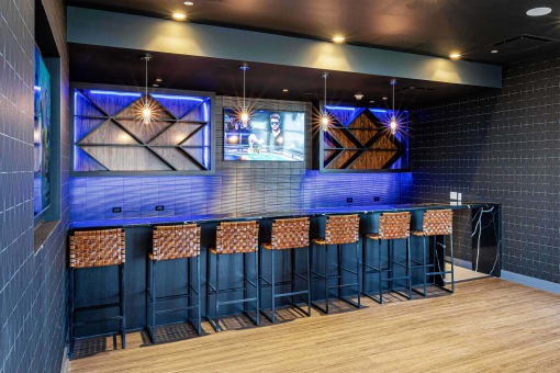 3thirty3 new rochelle ny apartment high rise photo of sports pub area with bar seating and multiple televisions TVs and modern furniture and lighting