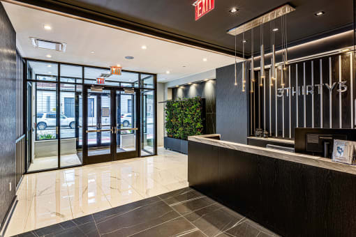 3thirty3 new rochelle ny apartment high rise photo of main entrance lobby with concierge desk and modern finishes