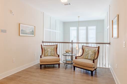 Resident sitting area with comfortable seating and natural light at Sage 5430 apartments near Historic Downtown Norcross.