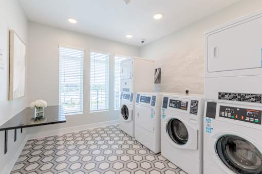 Convenient resident laundry facility with modern washers and dryers at Sage 5430 apartments in Gwinnett County.