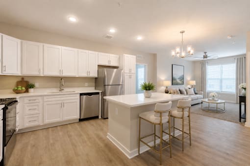 Open-concept one and two bedroom apartment with quartz countertops, stainless steel appliances, kitchen island, and spacious living area at Sage 5430 in Norcross, GA near Buford Highway and I-85.