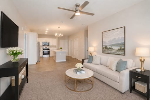 Beautifully staged apartment living room with modern finishes and open-concept design at Sage 5430 in Norcross near Jimmy Carter Boulevard.
