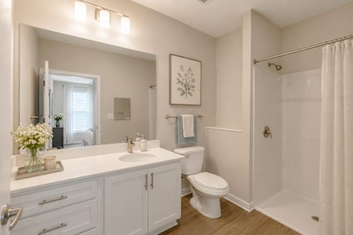Modern apartment bathroom with large vanity, walk-in shower, and contemporary finishes at Sage 5430 in Norcross.