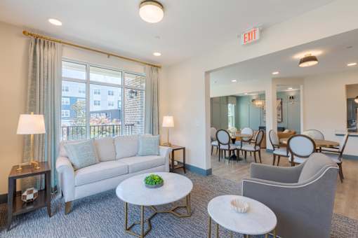 Comfortable resident lounge with natural light and inviting seating at Sage 5430 near The Forum Peachtree Corners.