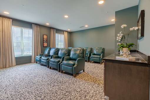 Resident media lounge with comfortable theater seating at Sage 5430, a welcoming 55+ apartment community in Norcross, Georgia.