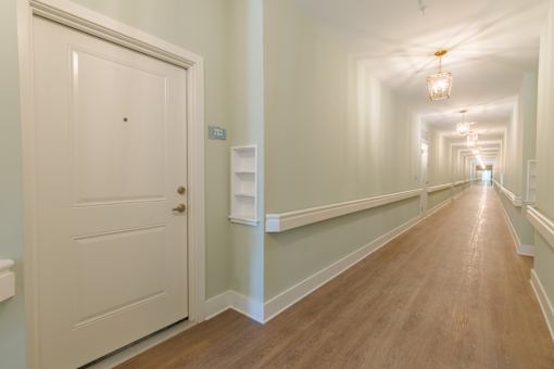 Bright interior hallway with elevator access and modern finishes inside Sage 5430 apartments in Norcross, GA.
