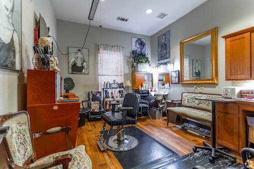 A room with a lot of furniture and a mirror on the wall.