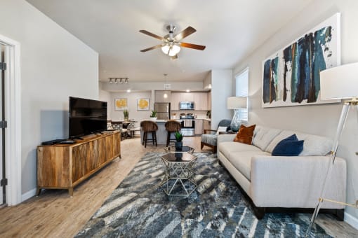 Bright and spacious living room with luxury vinyl plank flooring in a pet-friendly Santa Rosa Beach apartment.