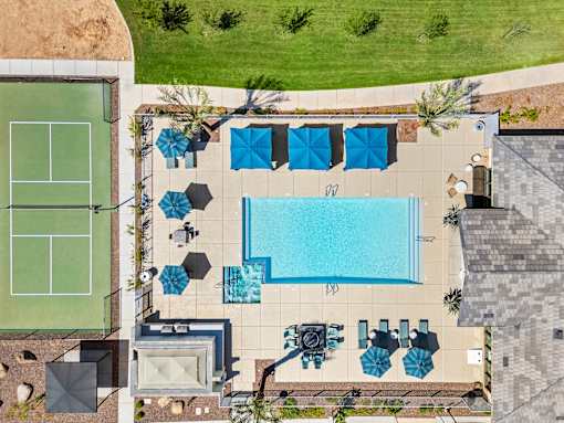 A pool with a tennis court next to it.