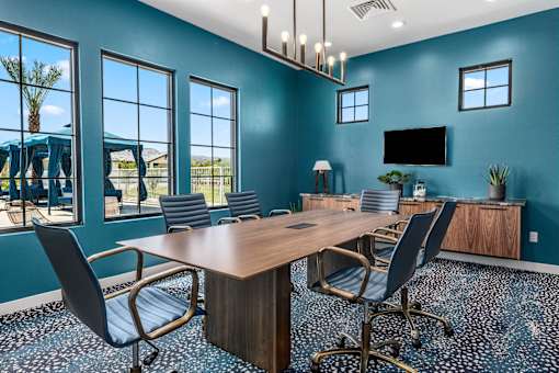 A conference room with a long table and chairs.