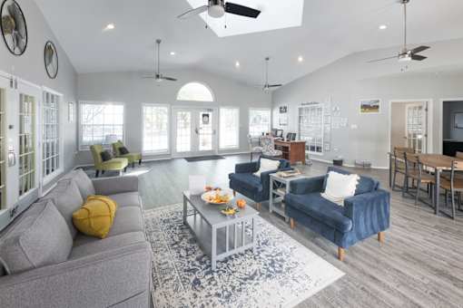 A living room with a grey couch and a blue couch.