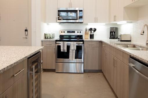 A modern kitchen with a stainless steel oven and microwave above the stove.