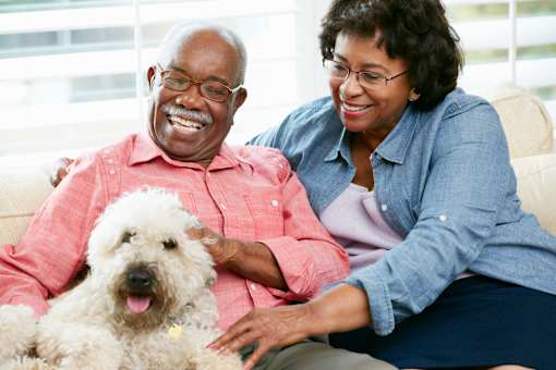 Happy senior couple with pet dog at Sage 5430 pet-friendly apartments in Norcross