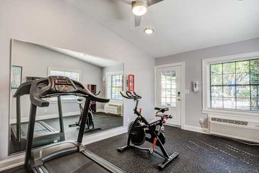 a home gym with a treadmill and exercise bike