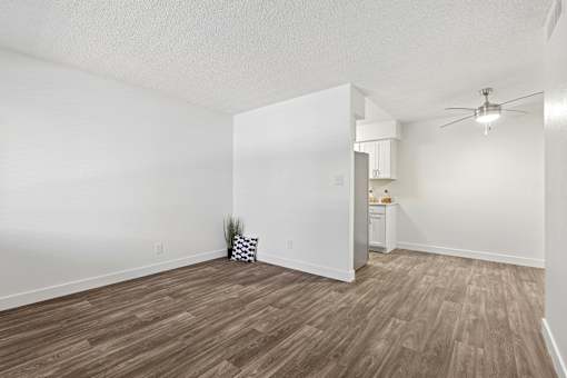 A room with a wooden floor and a ceiling fan.