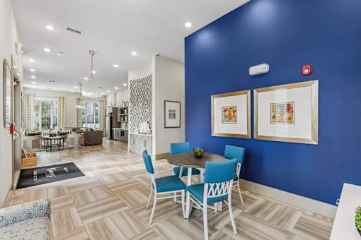 A dining room with a table set for four.