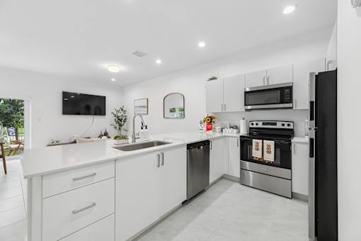 modern kitchen with stainless steel appliances at Pearl at Pompano Beach homes for rent in Pompano Beach FL