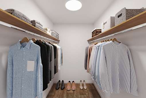 A row of shirts hangs on a rack in a clothing store.