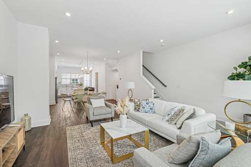 A modern living room with a white couch and a coffee table.