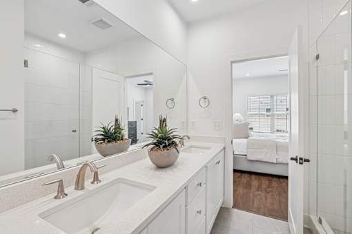 A bathroom with a white sink and a mirror.