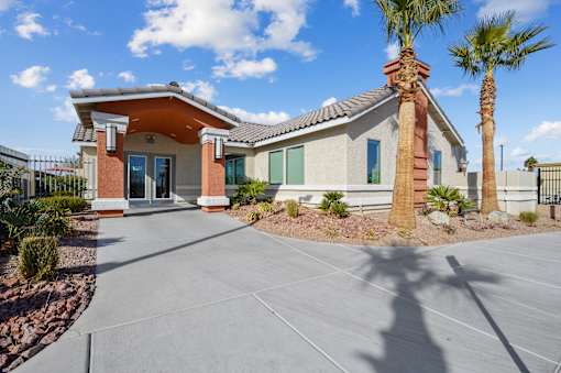 A house with a palm tree in front.