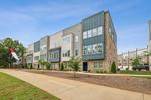 A modern building with a flag on the left side.