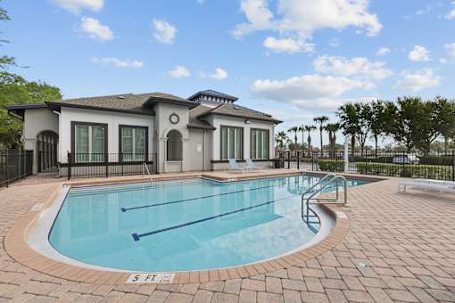 A small pool in front of a house.