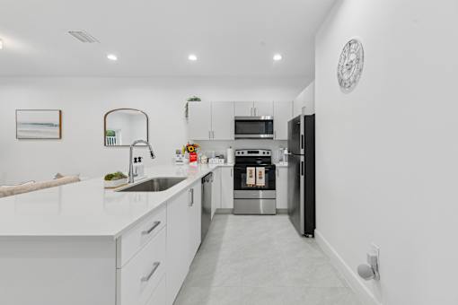 bright open kitchen with island and modern finishes in 3 bedroom home for rent Pompano Beach FL