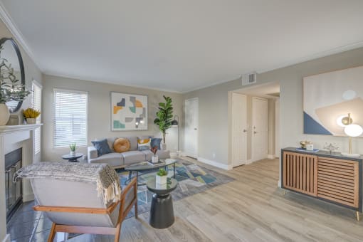 Two Bedroom Apartments In Moreno Valley, CA - Ardella On Chagall - Bright Modern Living Room With A Grey Sofa, Geometric Rug, Fireplace, And Mid-Century Modern Furniture.