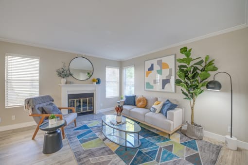 Dog Friendly Apartments in Moreno Valley CA - Ardella on Chagall - Living Room with Couch, Coffee Table, Chair, Area Rug, Fireplace, and Windows