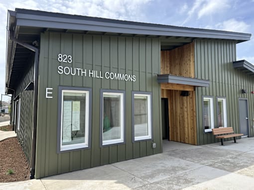 A green building with the number 823 and the words South Hill Commons on it.