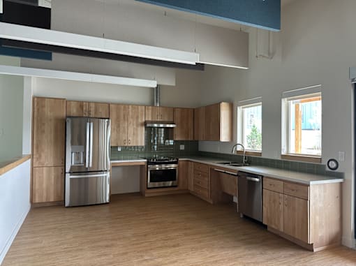 A modern kitchen with wooden cabinets and stainless steel appliances.