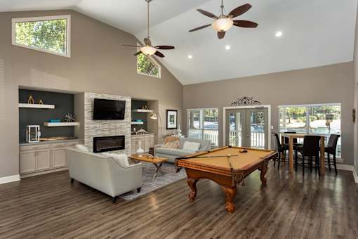 Clubhouse with billiards table and lounge area in Stockbridge GA apartment community