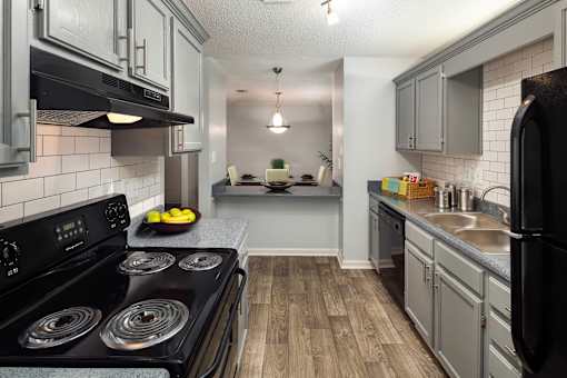 Kitchen and living room apartment in Stockbridge GA with wood-style flooring and natural light