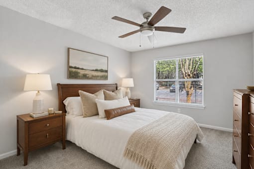 Spacious bedroom with large window inside a one, two and three bedroom apartment at Southwinds Point Apartments in Stockbridge, GA.