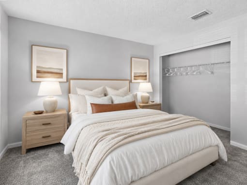 Comfortable bedroom with neutral finishes at Southwinds Point Apartments offering pet-friendly one, two and three bedroom apartment homes in Stockbridge, GA.