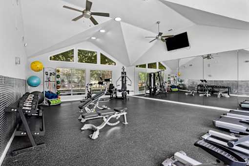 Fitness center with strength and cardio equipment at Southwinds Point Apartments in Stockbridge, GA.